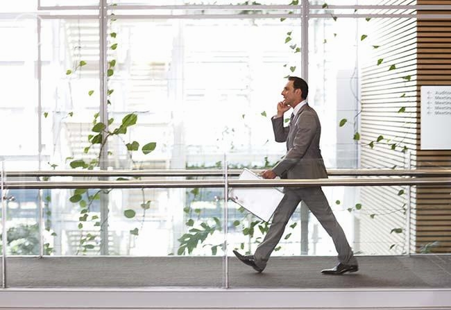 Businessman walking on office walkway